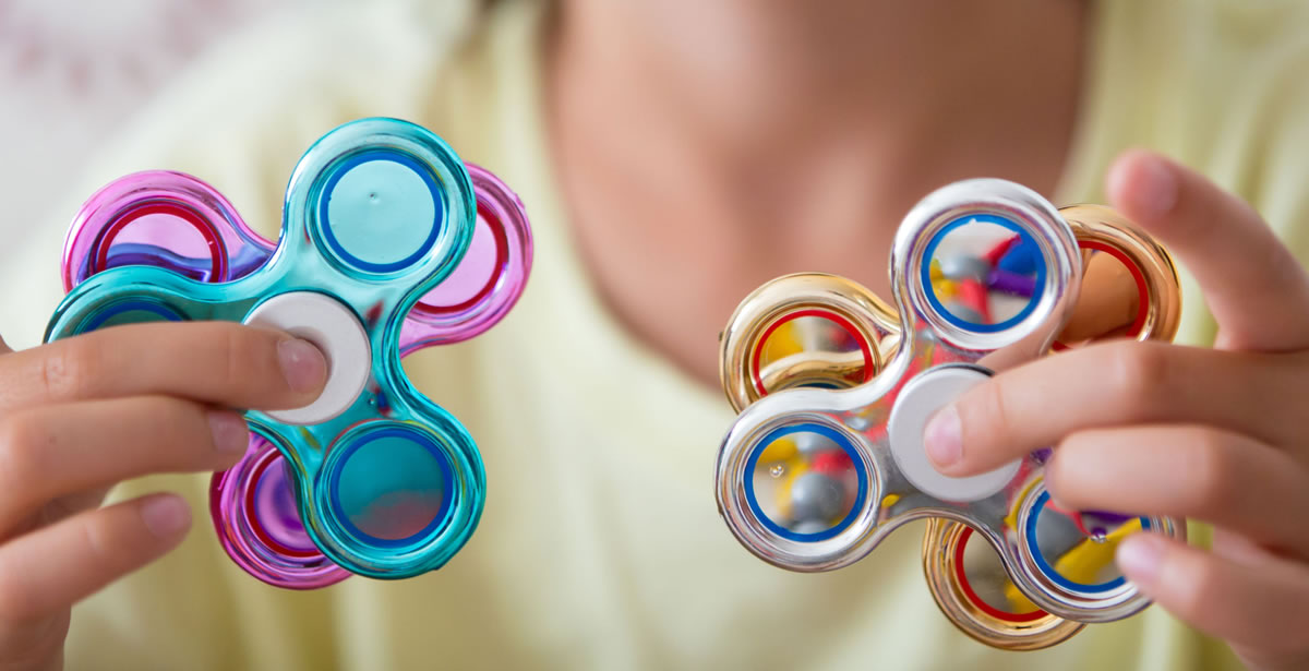 Boy-holding-fidget-spinners